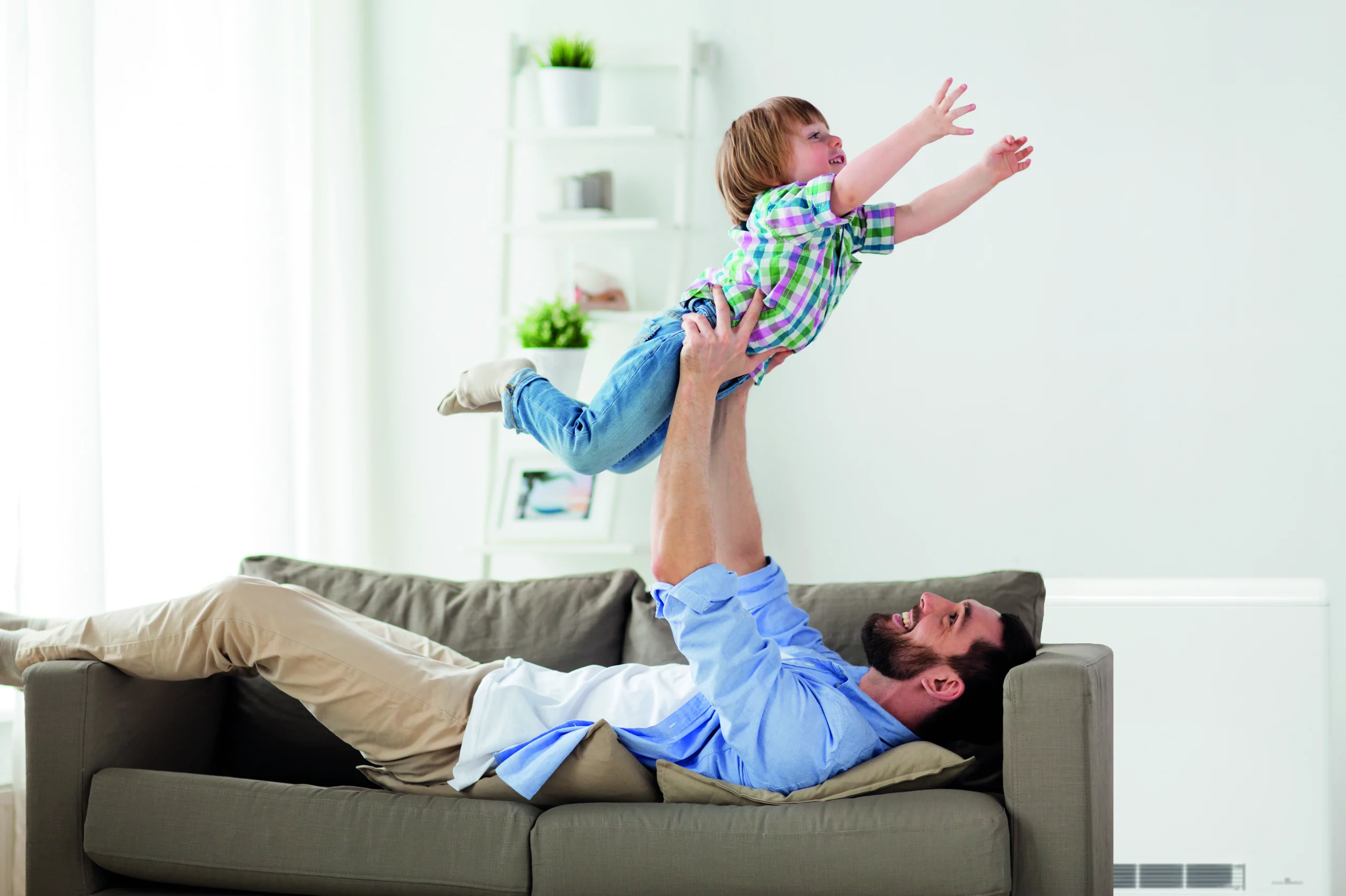 ECOHHR PLUS Lifestyle image with father holding up on and the heater being in the background